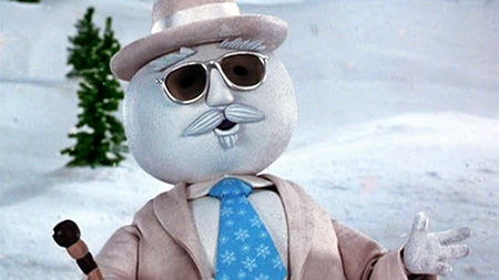 Snowman wearing sunglasses and a suit with a blue tie