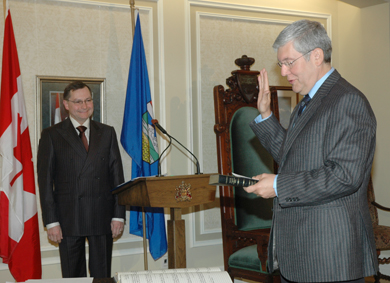 Dave Hancock swearing in as minister of education while Premier Ed Stelmach looks on.