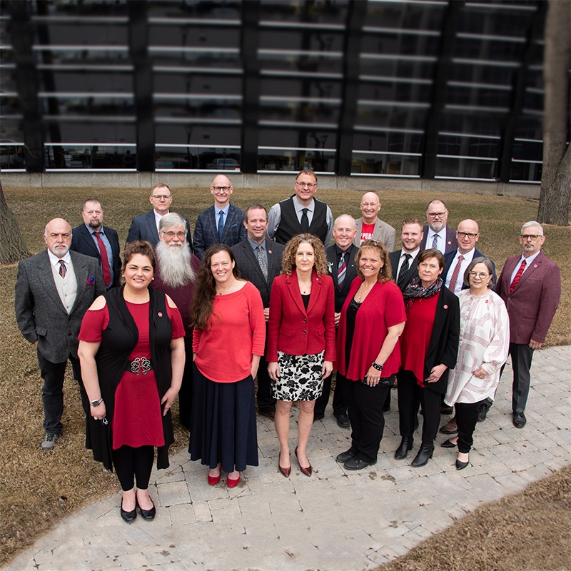 Outside photograph of the ATA's Provincial Executive council wearing red for Ed in front of the Association's building.