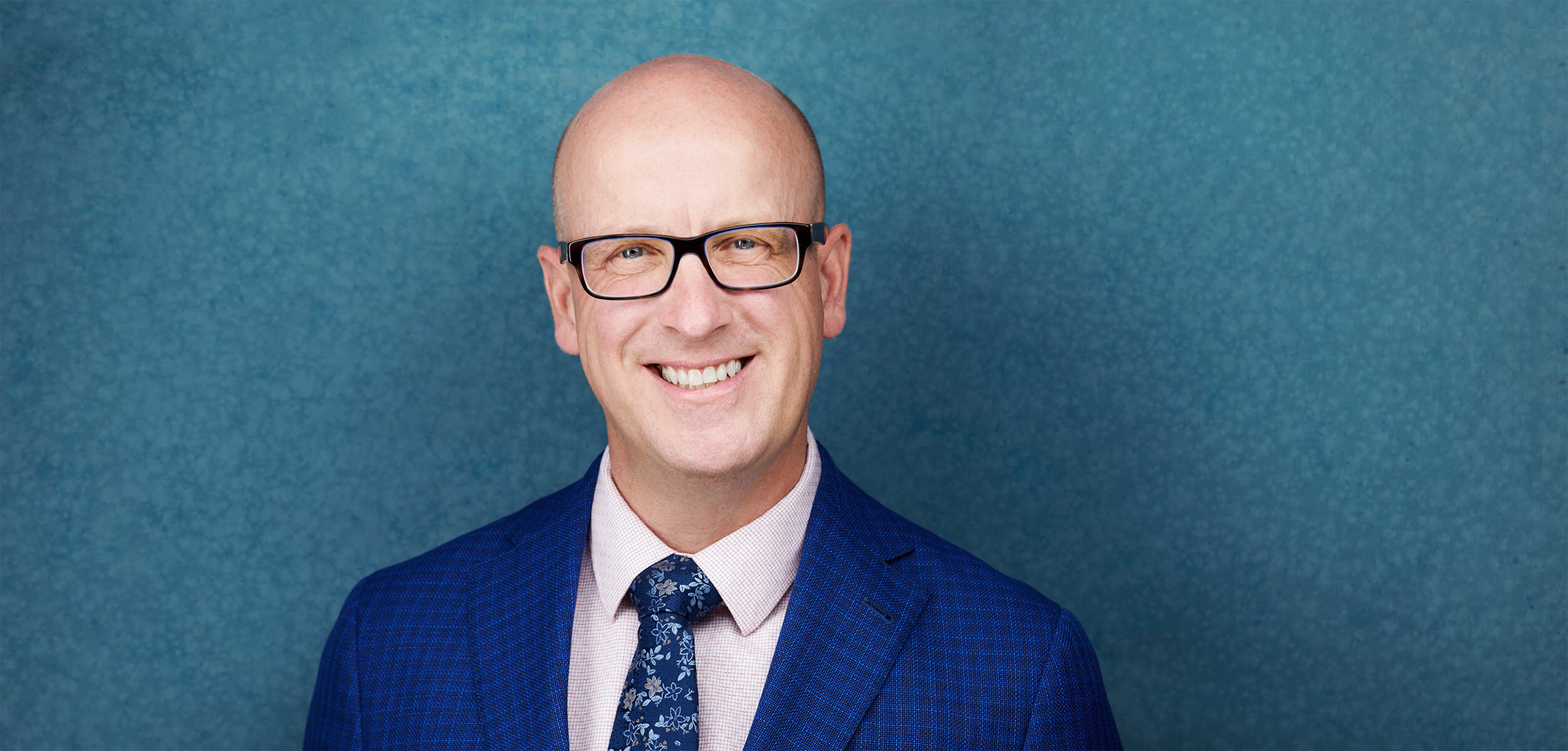 ATA president, Jason Schilling standing in a blue suit in front of a blue background.