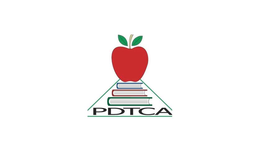 Red apple on a stack of three books with the acronym of Palliser District Teachers' Convention Association