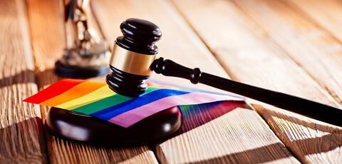 A gavel resting on a pride flag